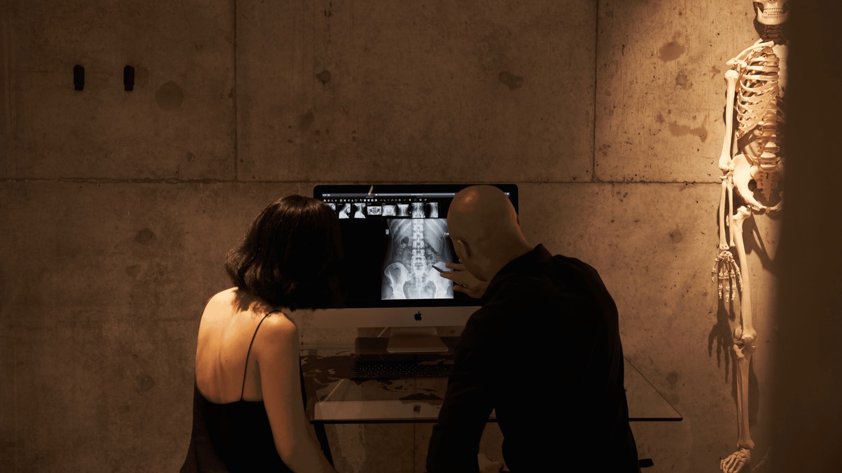 Chiropractor reviewing a spinal X-ray with a client